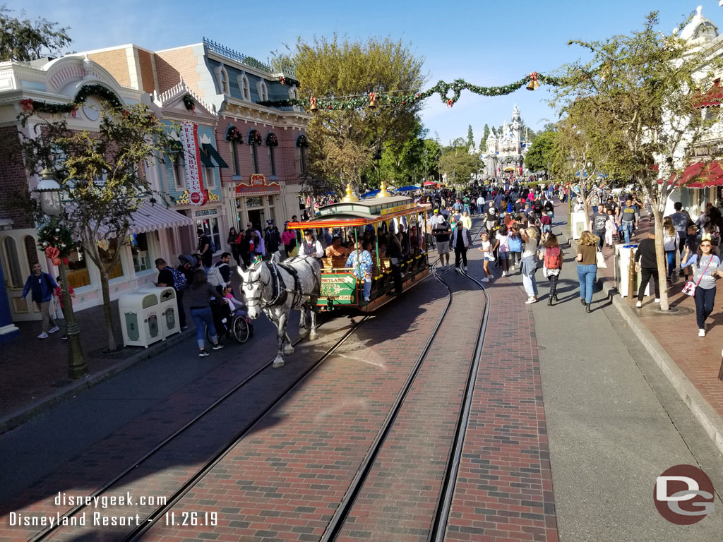 Horse drawn street car passing by.