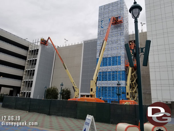 At the Mickey and Friends Parking Structure they are working on the elevator shaft exterior and the paneling for the stair well this afternoon.