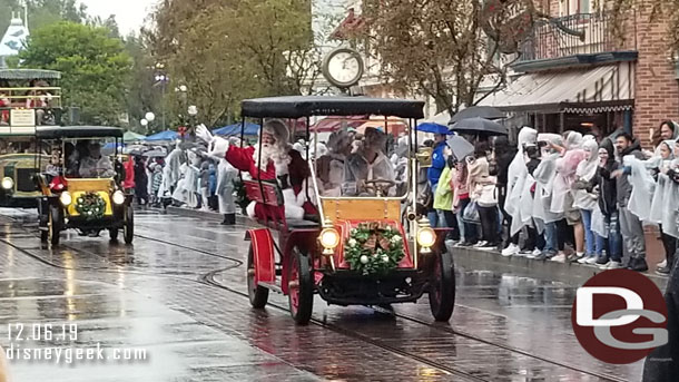 Santa Claus and Mrs. Claus in the lead car.