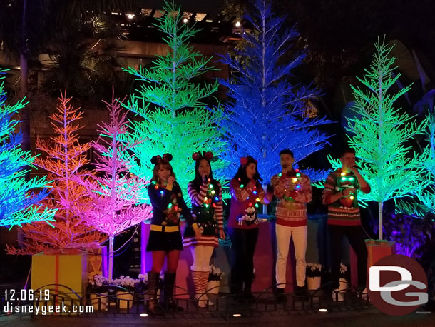 Holiday Harmony performing on the small stage outside the former Rain Forest Cafe (where the parrots used to come out).