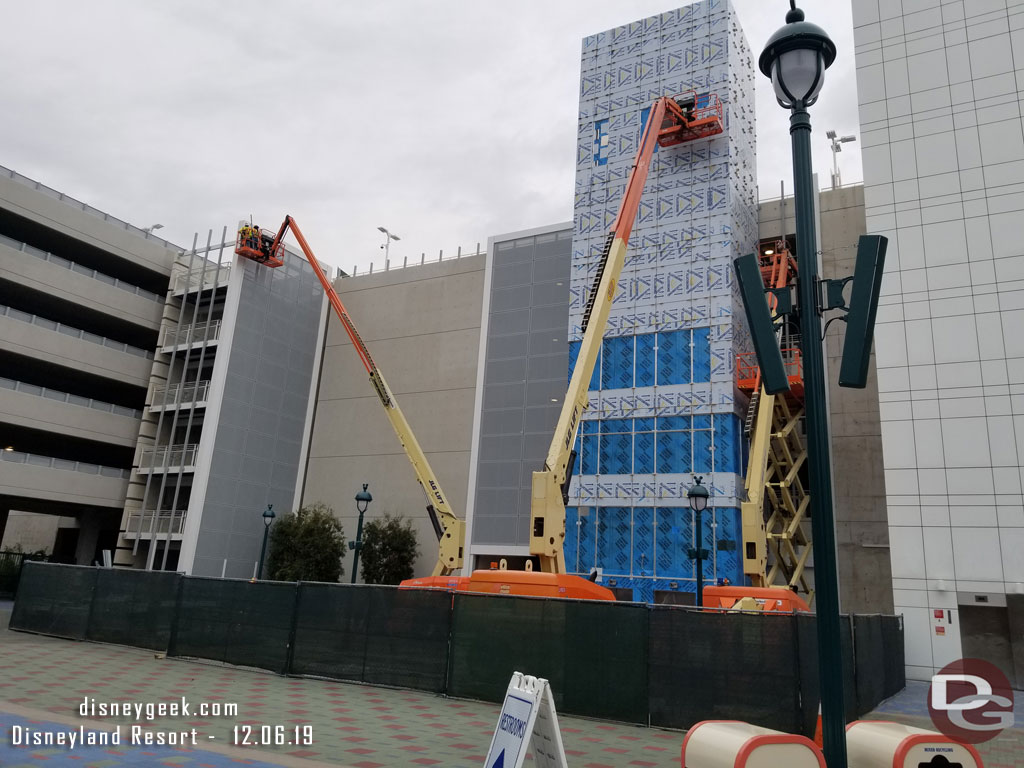 At the Mickey and Friends Parking Structure they are working on the elevator shaft exterior and the paneling for the stair well this afternoon.