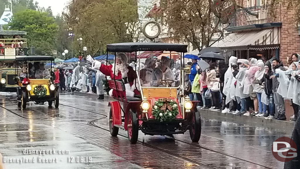 Santa Claus and Mrs. Claus in the lead car.