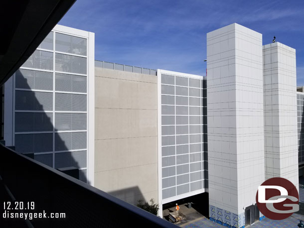 Work is nearing completion on the Mickey and Friends parking structure projects.  The second elevator shaft is mostly covered and the metal mesh and other decorative elements have been added to the side facing the tram plaza.