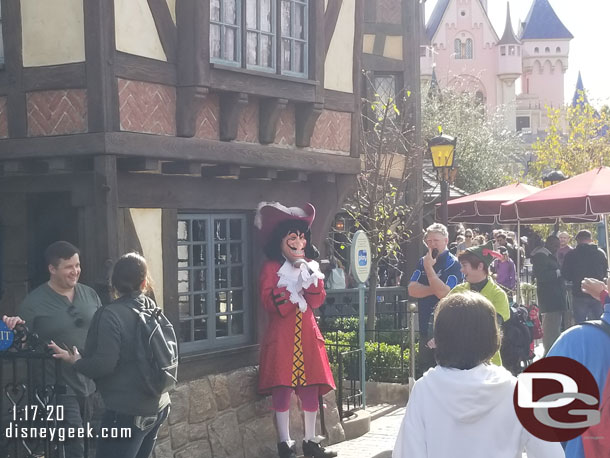 Captain Hook and Peter Pan were near the exit of their attraction and they were waiting and trying to scare guests as they exited.