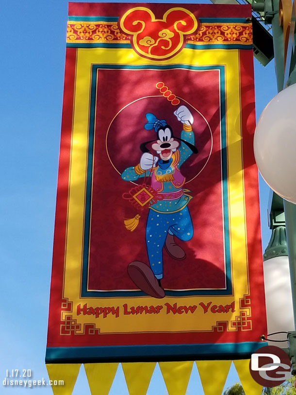 Happy Lunar New Year banners line the parade route. Here is one with Goofy.