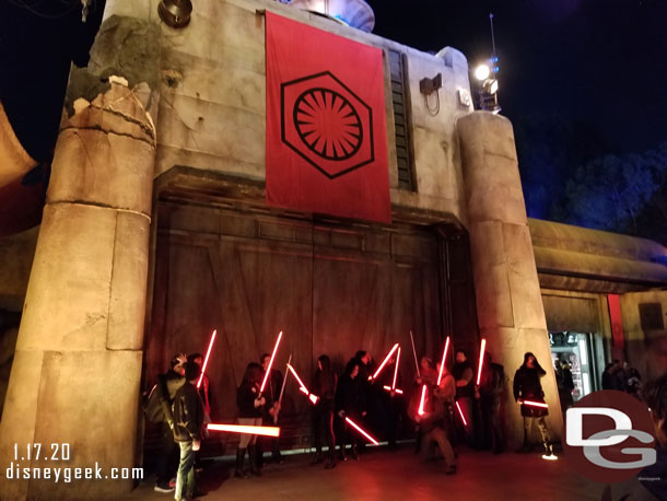 A group of guests with red lightsabers taking a group photo.