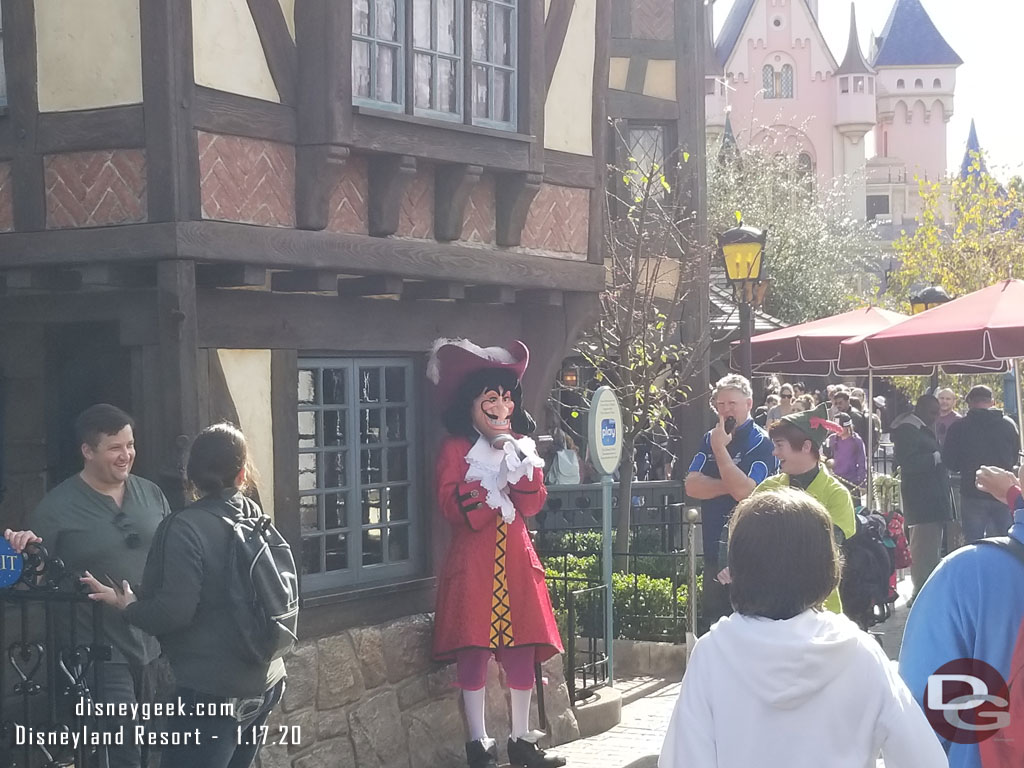 Captain Hook and Peter Pan were near the exit of their attraction and they were waiting and trying to scare guests as they exited.