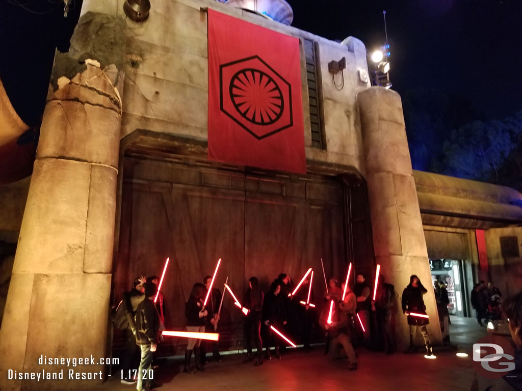 A group of guests with red lightsabers taking a group photo.