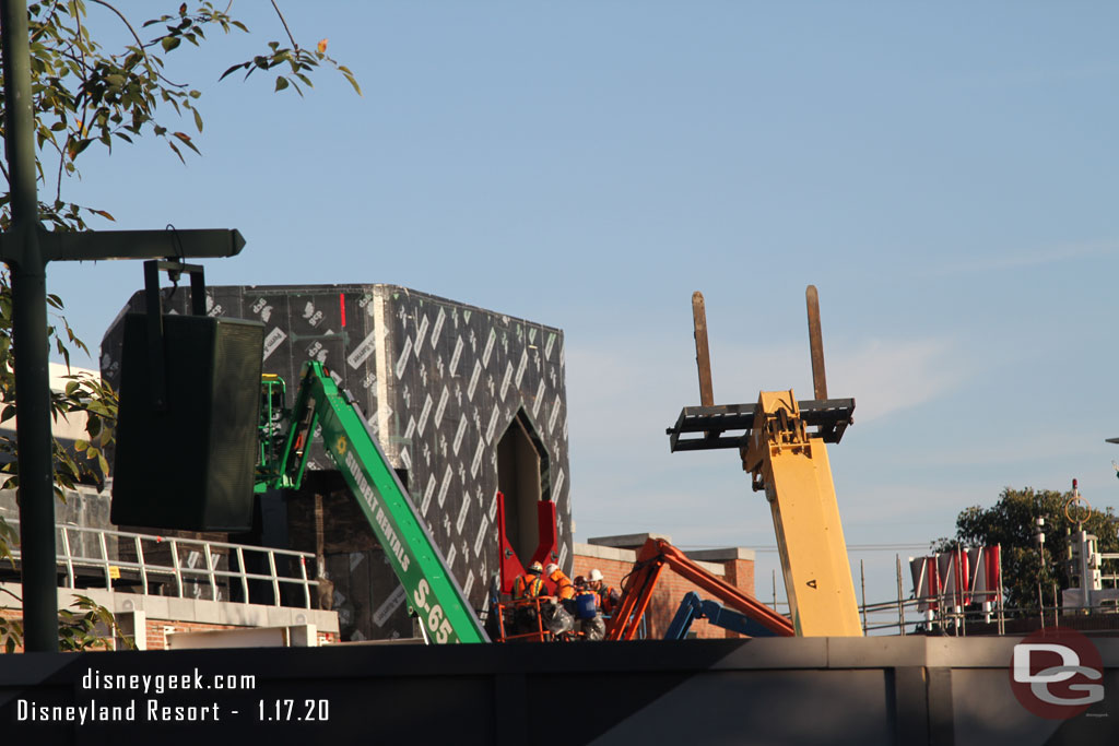 A team is installing the first element on this portion of the facade around the hexagon.