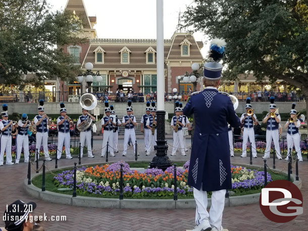 The Disneyland Band gathered around the flag pole