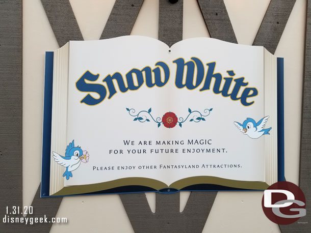 The walls around Snow White feature some signs and artwork.