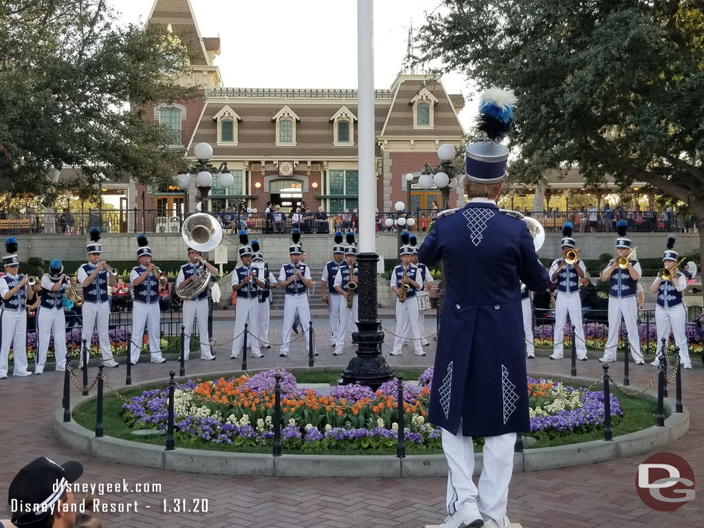 The Disneyland Band gathered around the flag pole