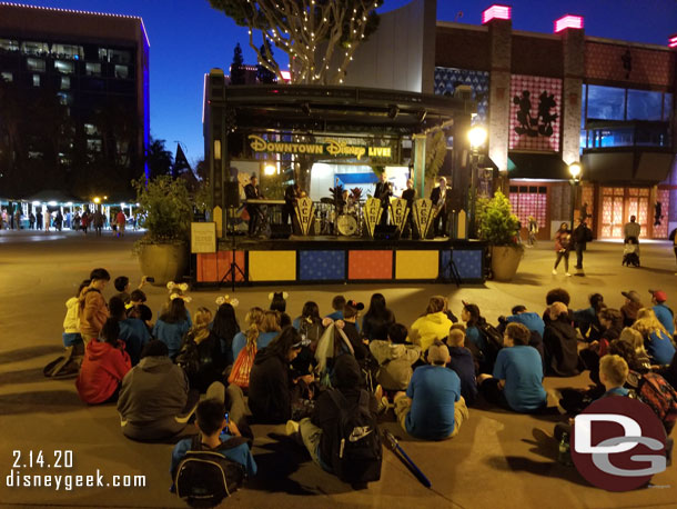 A group of sitting to watch the performance by the Amanda Castro Band this evening on the West End stage in Downtown Disney.