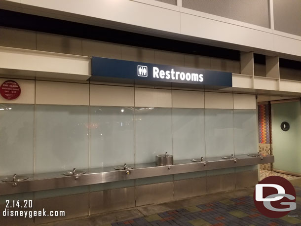 Mickey and Friends Parking Structure restroom sign lights up at night.