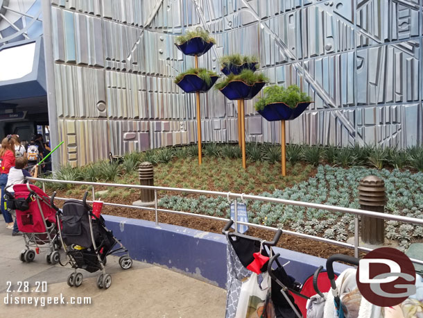 The planters appear to be finished on both sides of the Tomorrowland entrance.