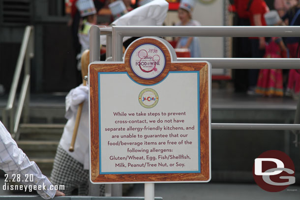 Signs up near the Backlot stage with a food warning.