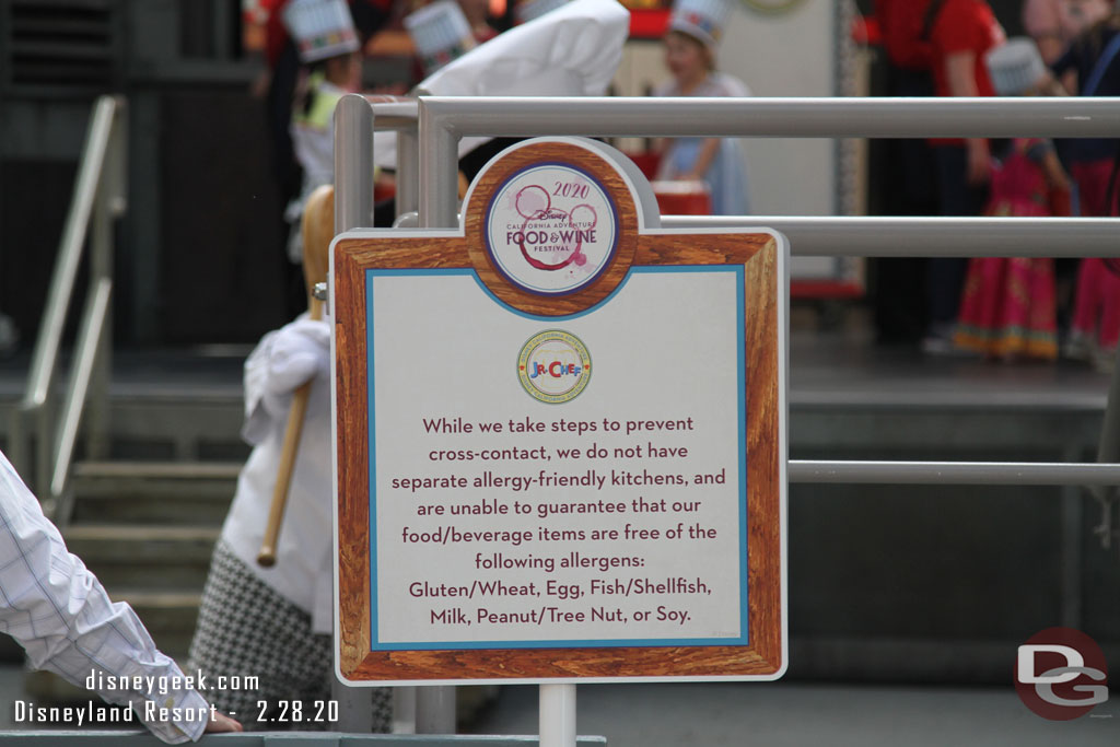 Signs up near the Backlot stage with a food warning.