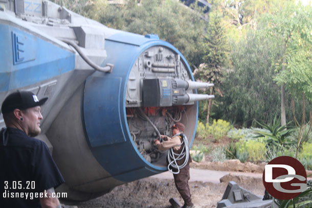 A cast member working on the exterior of the shuttle, noticed one the first time through too. They had prop wrenches and equipment.