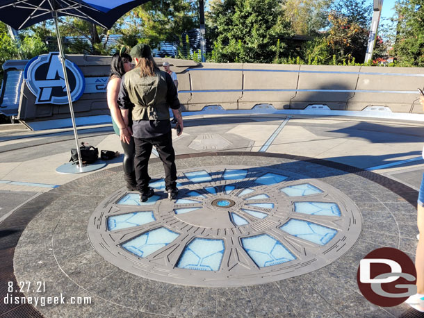 A PhotoPass location set up at the sign.