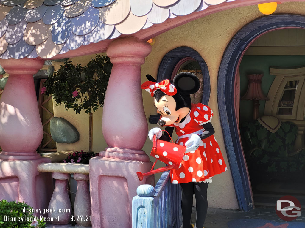 Minnie Mouse watering plants at her house