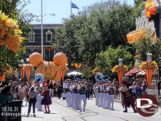 The Disneyland Band with Mickey Mouse and Minnie Mouse making their way up Main Street USA