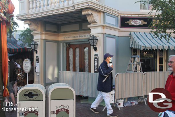 Painting the exterior of the Photo Supply store as it transitions to a Holiday store.