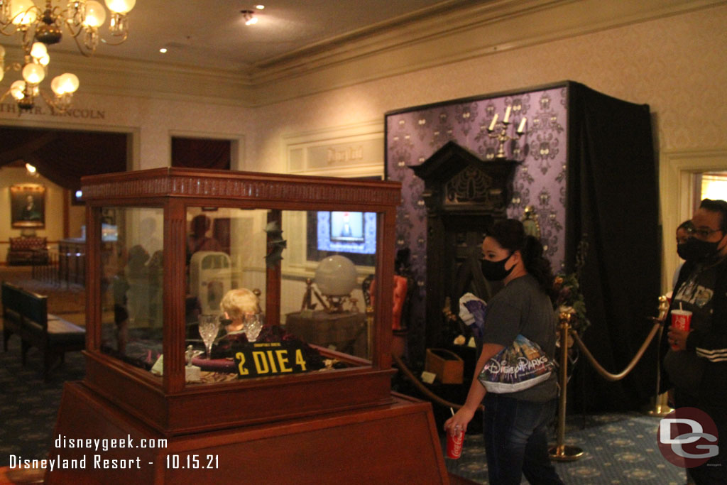 The display case in the center of the lobby and a small display near the TV have been added to promote the Muppets Haunted Mansion.