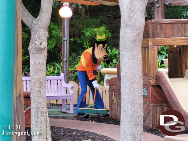 Spotted Goofy sweeping up his backyard.