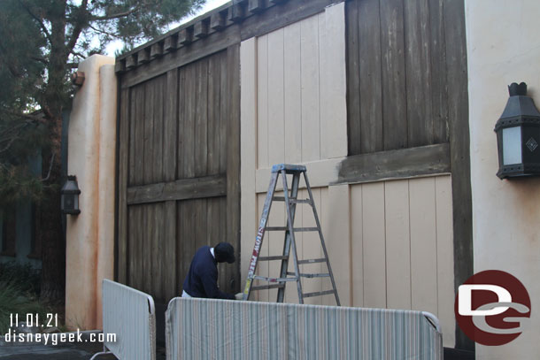 Cast Members were repainting the backstage gates in the Pacific Wharf area near Cars Land.