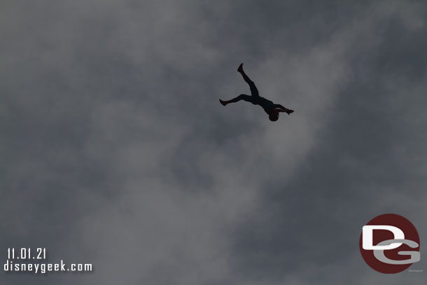 Spider-Man flying through the air on this overcast morning.