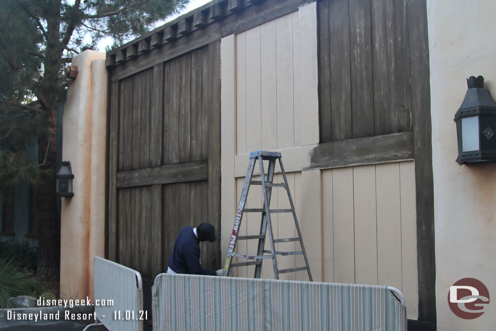 Cast Members were repainting the backstage gates in the Pacific Wharf area near Cars Land.