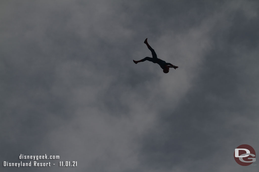 Spider-Man flying through the air on this overcast morning.