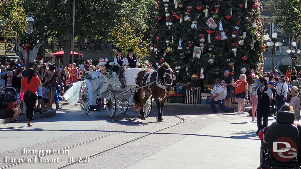 Mickey leads the cavalcade in a horse drawn carriage.