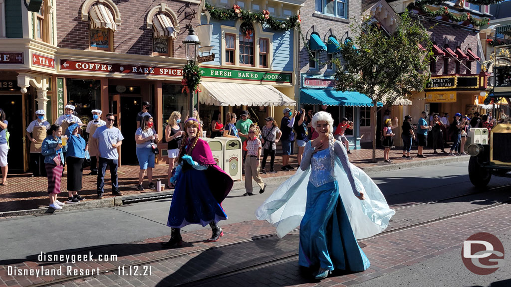 Anna & Elsa walking behind Mickey.