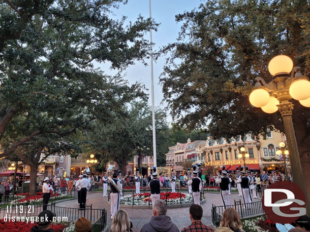 Disneyland Band and security honor guard gathered around the flag pole for the nightly Flag Retreat Ceremony.