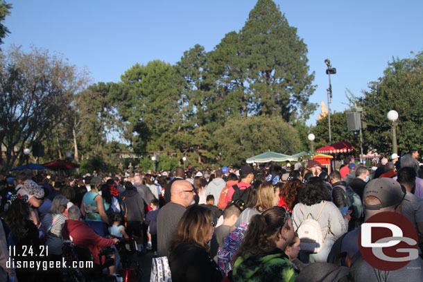 8:00am, park opening crowd in the hub starting to move out into the park.