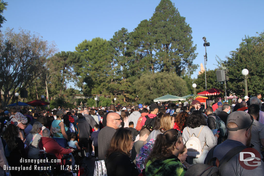 8:00am, park opening crowd in the hub starting to move out into the park.