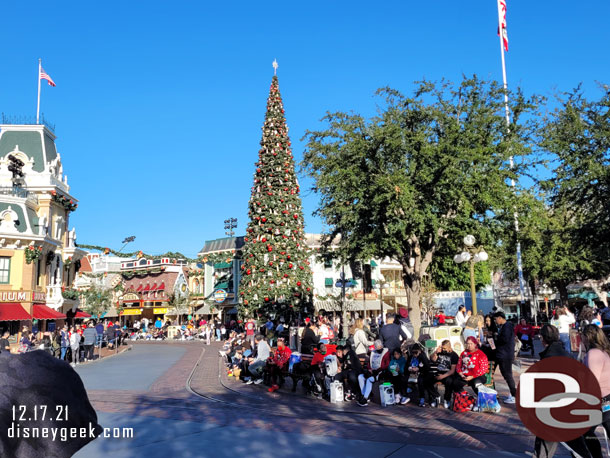 Guests lining Main Street USA waiting for the 2pm A Christmas Fantasy Parade to arrive.