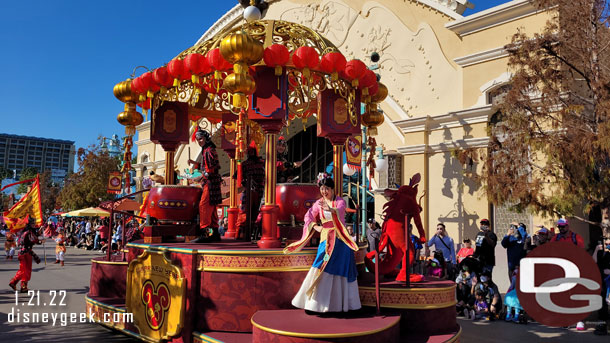 Mulan and Mushu ride aboard a float this year.