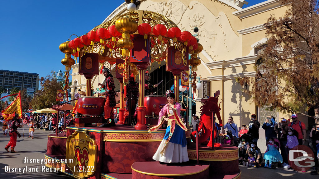 Mulan and Mushu ride aboard a float this year.