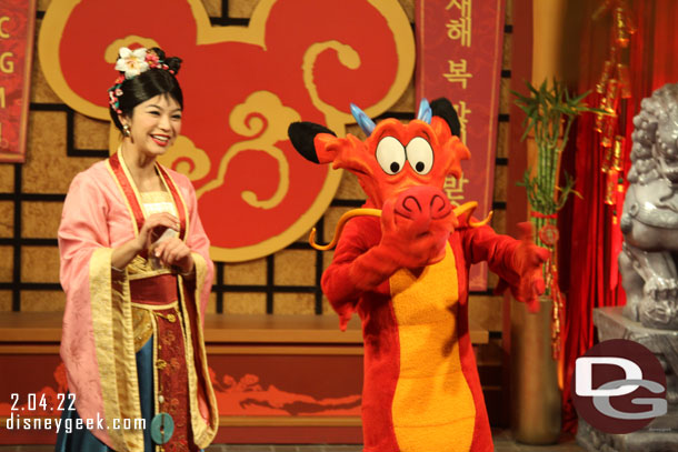 Mulan and Mushu greeting guests