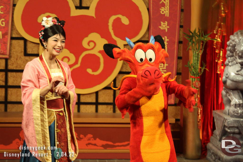 Mulan and Mushu greeting guests