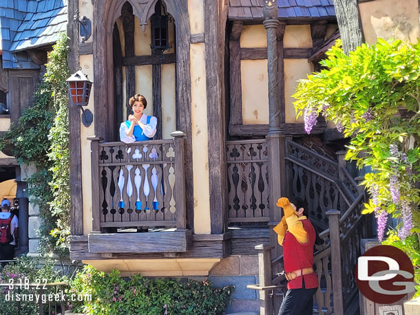 Belle and Gaston were interacting with guests nearby.