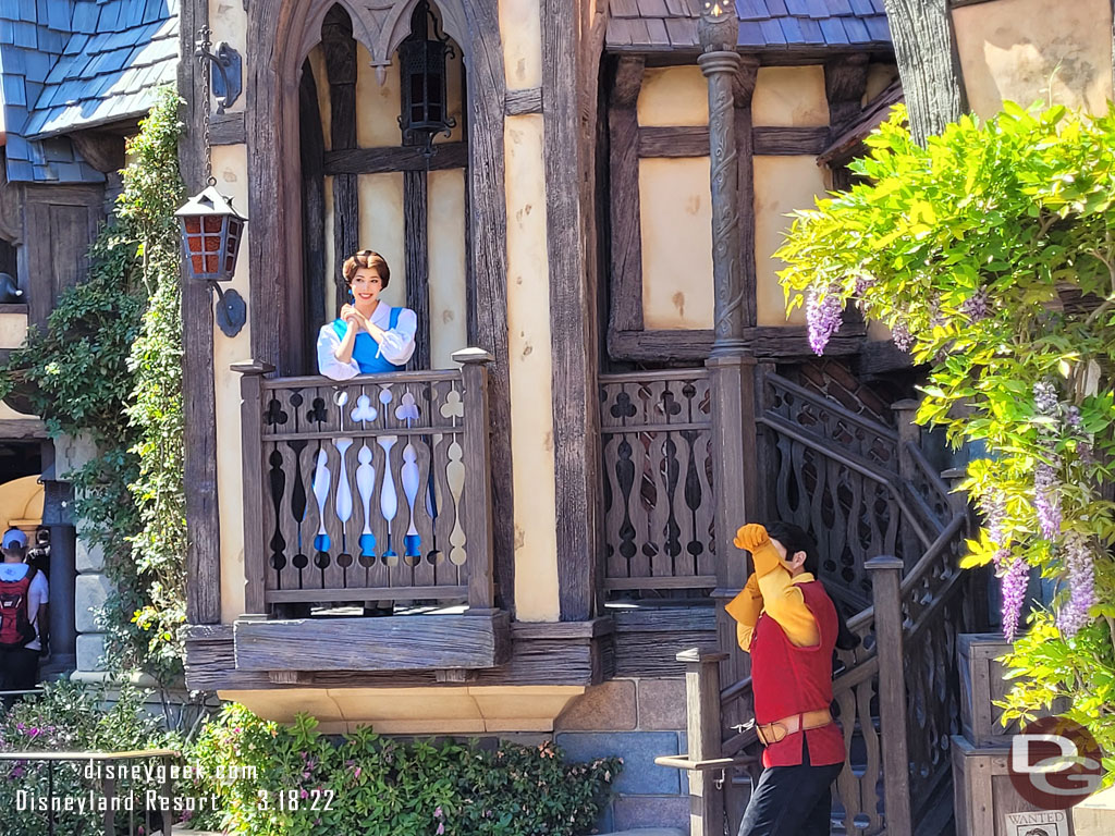 Belle and Gaston were interacting with guests nearby.