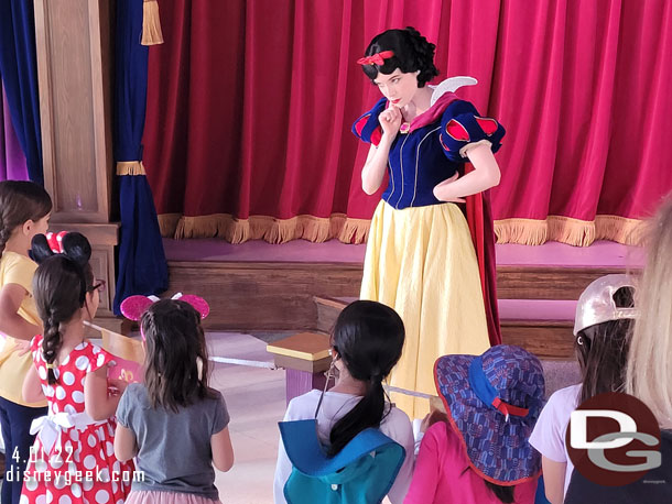 Snow White visiting with a half dozen kids.