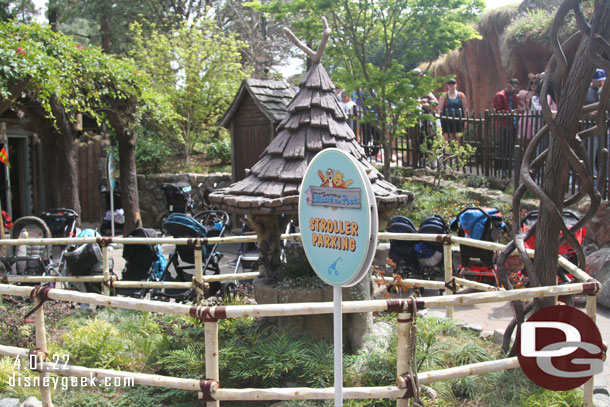 The former Splash Mtn FastPass area is stroller parking for Winnie the Pooh, a sign to help guests find it.