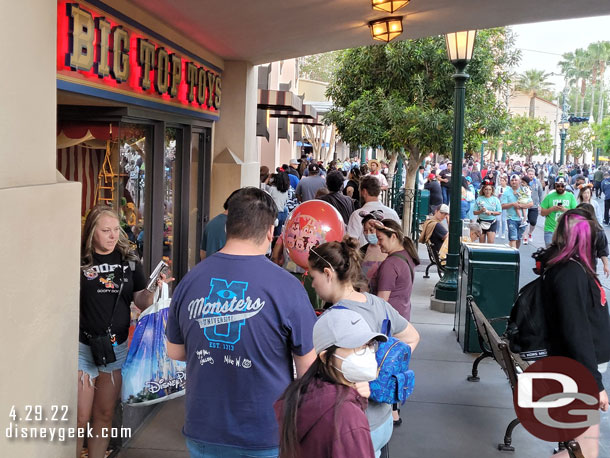 A long line on Buena Vista Street. Mickey Mouse is out by Elias & Co.. way in the distance