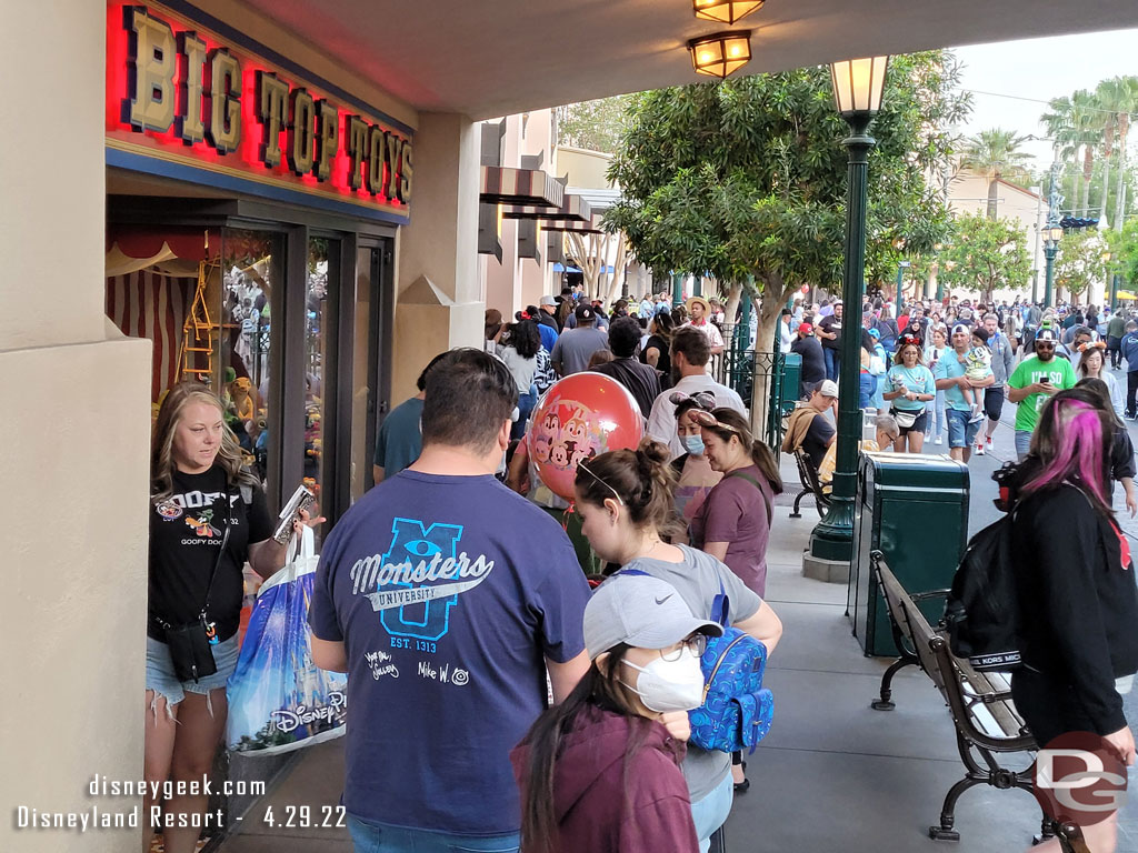 A long line on Buena Vista Street. Mickey Mouse is out by Elias & Co.. way in the distance