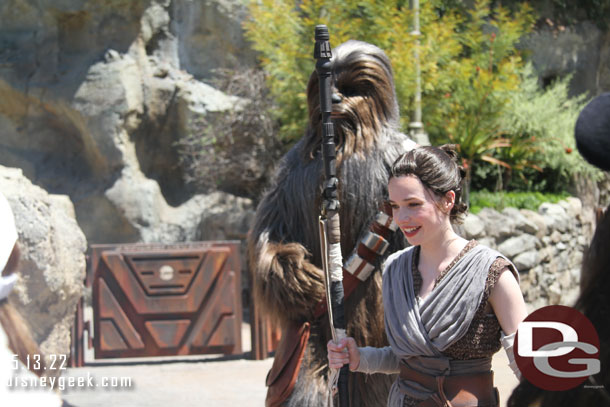 Rey and Chewie out working on an X-Wing and meeting guests.