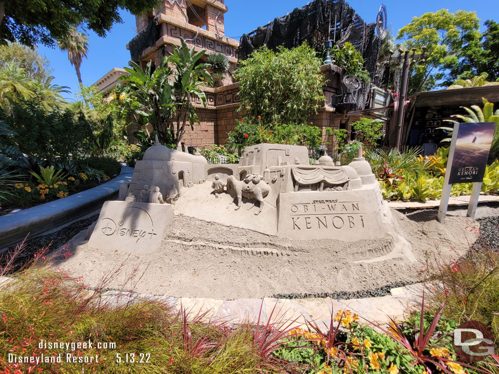 A sand sculpture in the garden near the Star Wars Trading Post promoting the upcoming Obi-Wan Kenobi series on Disney+